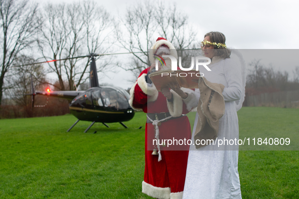 Santa Claus with an angel arrives in Essen Steele, Germany, on December 6, 2024. 