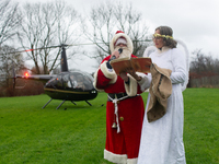 Santa Claus with an angel arrives in Essen Steele, Germany, on December 6, 2024. (