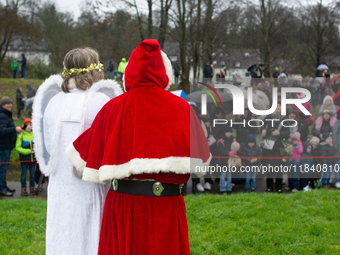 Santa Claus with an angel arrives in Essen Steele, Germany, on December 6, 2024. (