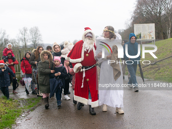 Santa Claus with an angel arrives in Essen Steele, Germany, on December 6, 2024. (