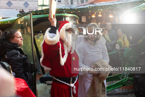 Santa Claus with an angel arrives at a local Christmas market in Essen Steele, Germany, on December 6, 2024. 