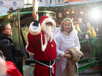 Santa Claus with an angel arrives at a local Christmas market in Essen Steele, Germany, on December 6, 2024. (