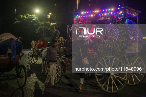 City dwellers ride on a horse cart during a public holiday in Dhaka, Bangladesh, on December 6, 2024. Horse cart rides, a nostalgic mode of...