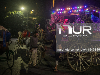 City dwellers ride on a horse cart during a public holiday in Dhaka, Bangladesh, on December 6, 2024. Horse cart rides, a nostalgic mode of...