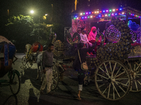 City dwellers ride on a horse cart during a public holiday in Dhaka, Bangladesh, on December 6, 2024. Horse cart rides, a nostalgic mode of...