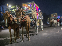 Horse carts wait by the roadside for city dwellers to take leisurely rides during a public holiday in Dhaka, Bangladesh, on December 6, 2024...