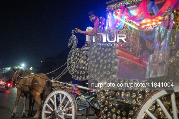 A boy waits with his horse cart and calls for passengers during a public holiday in Dhaka, Bangladesh, on December 6, 2024. Horse carts rema...