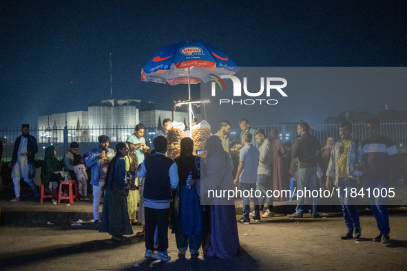 City dwellers gather in front of the National Parliament in Dhaka, Bangladesh, on December 6, 2024, during a public holiday. Makeshift shops...