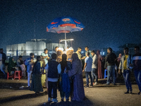 City dwellers gather in front of the National Parliament in Dhaka, Bangladesh, on December 6, 2024, during a public holiday. Makeshift shops...