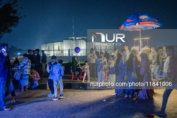 City dwellers gather in front of the National Parliament in Dhaka, Bangladesh, on December 6, 2024, during a public holiday. Makeshift shops...