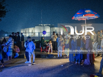 City dwellers gather in front of the National Parliament in Dhaka, Bangladesh, on December 6, 2024, during a public holiday. Makeshift shops...