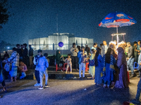 City dwellers gather in front of the National Parliament in Dhaka, Bangladesh, on December 6, 2024, during a public holiday. Makeshift shops...