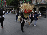 A person carries Christmas decorations on the streets of the Zocalo in Mexico City, Mexico, on December 6, 2024. (