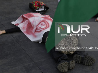 Palestinian activists and supporters demonstrate against the genocide in Gaza in the Zocalo of Mexico City, Mexico, on December 6, 2024, to...