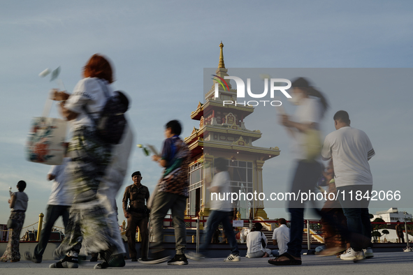 Buddhists and devotees pay homage to the Buddha's sacred tooth relics, which are temporarily enshrined in Thailand at the Sanam Luang ceremo...