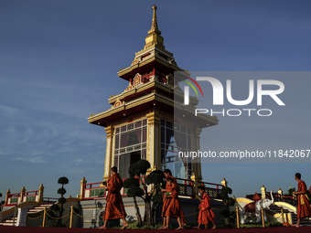 Buddhist monks chant and pay homage to the Buddha's sacred tooth relics, which are temporarily enshrined at the Sanam Luang ceremonial groun...