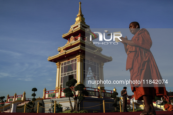 Buddhist monks chant and pay homage to the Buddha's sacred tooth relics, which are temporarily enshrined at the Sanam Luang ceremonial groun...