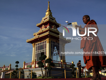 Buddhist monks chant and pay homage to the Buddha's sacred tooth relics, which are temporarily enshrined at the Sanam Luang ceremonial groun...