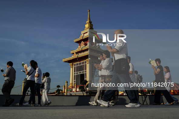 Buddhists and devotees pay homage to the Buddha's sacred tooth relics, which are temporarily enshrined in Thailand at the Sanam Luang ceremo...