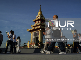 Buddhists and devotees pay homage to the Buddha's sacred tooth relics, which are temporarily enshrined in Thailand at the Sanam Luang ceremo...