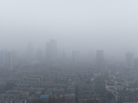 Buildings loom under heavy fog in Nanjing, China, on December 7, 2024. (