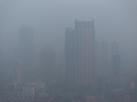 Buildings loom under heavy fog in Nanjing, China, on December 7, 2024. (