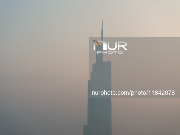 The Nanjing Zifeng Building looms under heavy fog in Nanjing, China, on December 7, 2024. 