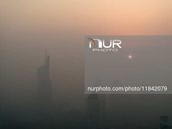 Buildings loom under heavy fog in Nanjing, China, on December 7, 2024. 