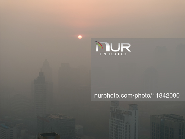 Buildings loom under heavy fog in Nanjing, China, on December 7, 2024. 