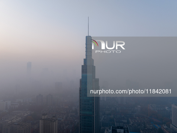 The Nanjing Zifeng Building looms under heavy fog in Nanjing, China, on December 7, 2024. 