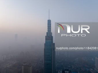 The Nanjing Zifeng Building looms under heavy fog in Nanjing, China, on December 7, 2024. (