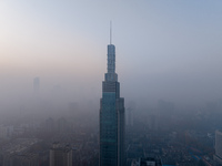 The Nanjing Zifeng Building looms under heavy fog in Nanjing, China, on December 7, 2024. (