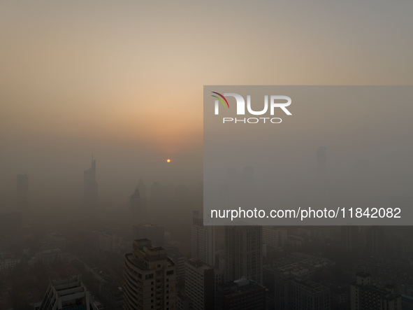 Buildings loom under heavy fog in Nanjing, China, on December 7, 2024. 