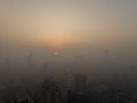 Buildings loom under heavy fog in Nanjing, China, on December 7, 2024. (