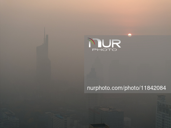 Buildings loom under heavy fog in Nanjing, China, on December 7, 2024. 