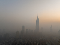 Buildings loom under heavy fog in Nanjing, China, on December 7, 2024. (