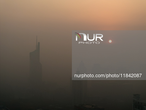 Buildings loom under heavy fog in Nanjing, China, on December 7, 2024. 