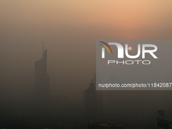 Buildings loom under heavy fog in Nanjing, China, on December 7, 2024. (