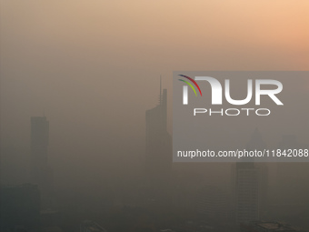 Buildings loom under heavy fog in Nanjing, China, on December 7, 2024. (