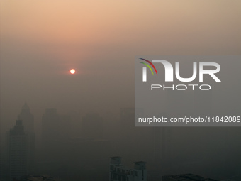 Buildings loom under heavy fog in Nanjing, China, on December 7, 2024. (