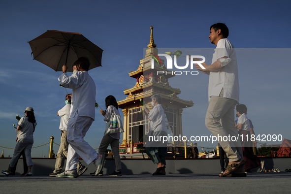 Buddhists and devotees pay homage to the Buddha's sacred tooth relics, which are temporarily enshrined in Thailand at the Sanam Luang ceremo...