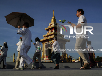 Buddhists and devotees pay homage to the Buddha's sacred tooth relics, which are temporarily enshrined in Thailand at the Sanam Luang ceremo...