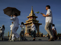 Buddhists and devotees pay homage to the Buddha's sacred tooth relics, which are temporarily enshrined in Thailand at the Sanam Luang ceremo...