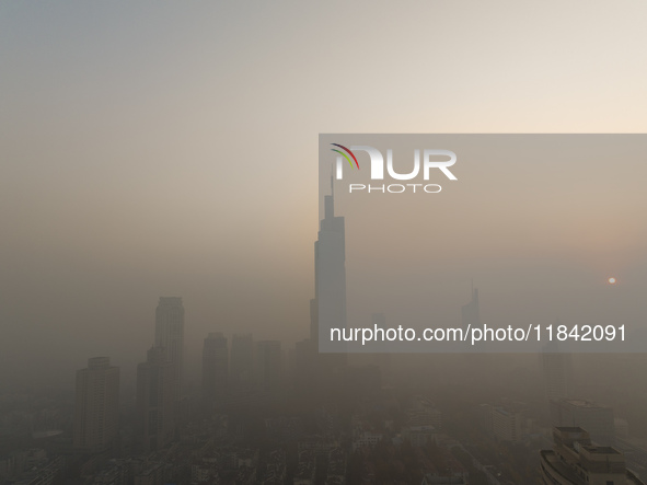 Buildings loom under heavy fog in Nanjing, China, on December 7, 2024. 