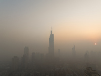 Buildings loom under heavy fog in Nanjing, China, on December 7, 2024. (