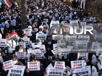 Hundreds of students from the National University Student Union gather in Yeouido, South Korea, on December 7, 2024, holding placards demand...