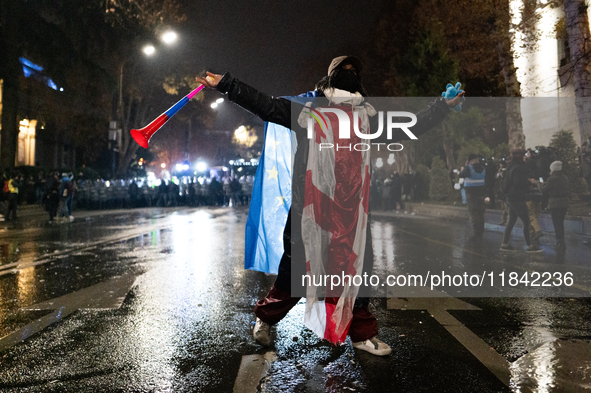 Anti-government protesters face police during a ninth consecutive day of mass demonstrations against the government's postponement of Europe...