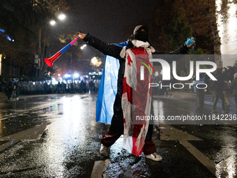 Anti-government protesters face police during a ninth consecutive day of mass demonstrations against the government's postponement of Europe...