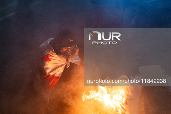 Anti-government protesters rally outside the parliament building during a ninth consecutive day of mass demonstrations against the governmen...