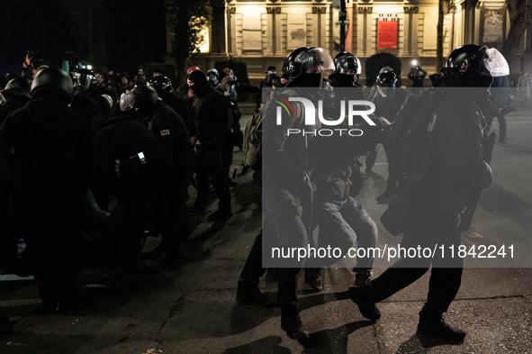 Police detain anti-government protesters during a ninth consecutive day of mass demonstrations against the government's postponement of Euro...